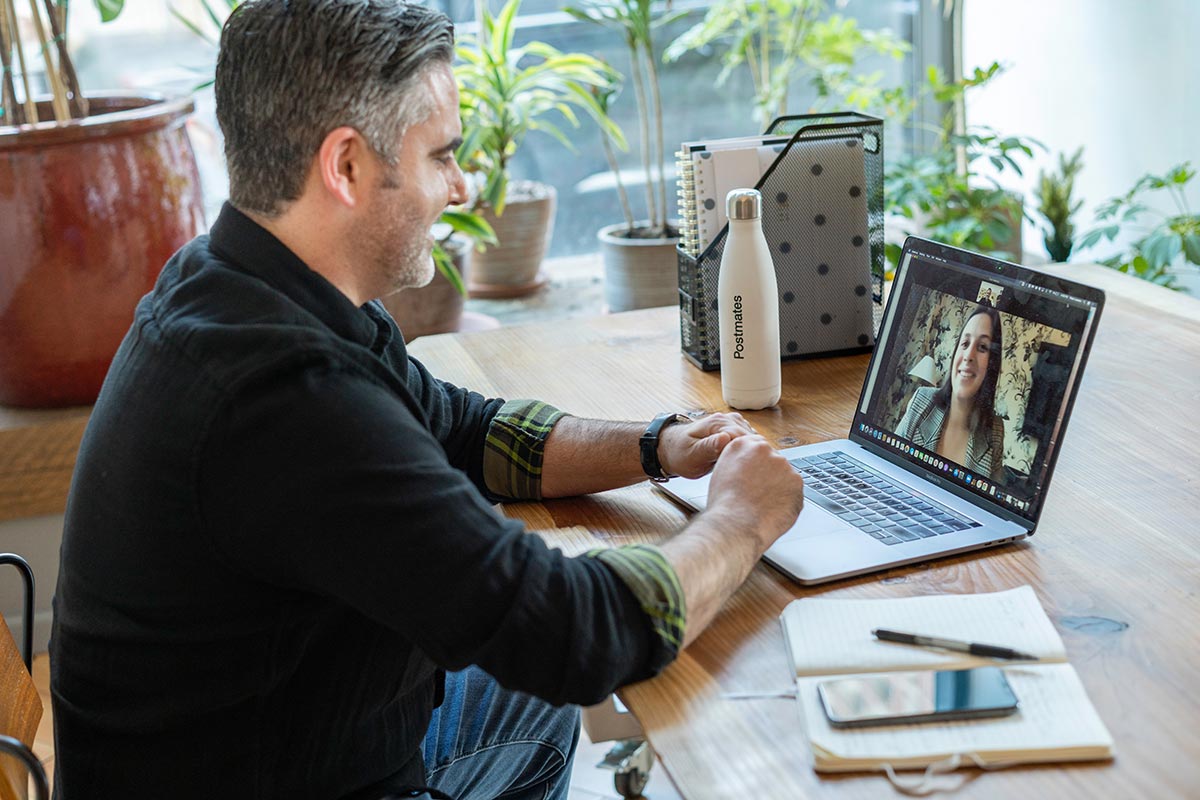 Man having a video conference meeting with colleague on laptop