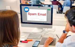 Office workers in front of computer with email open