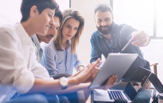 co-workers looking at tablet device