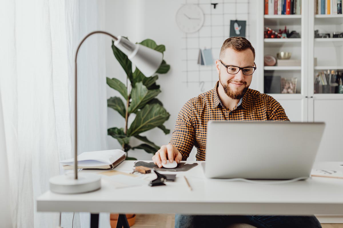 Young male working at home on laptop